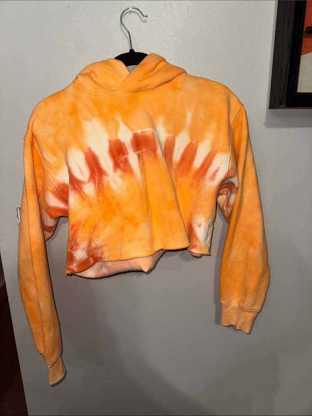 Tna by Aritzia Perfect Crop Hoodie in a vibrant orange and white sunset tie-dye